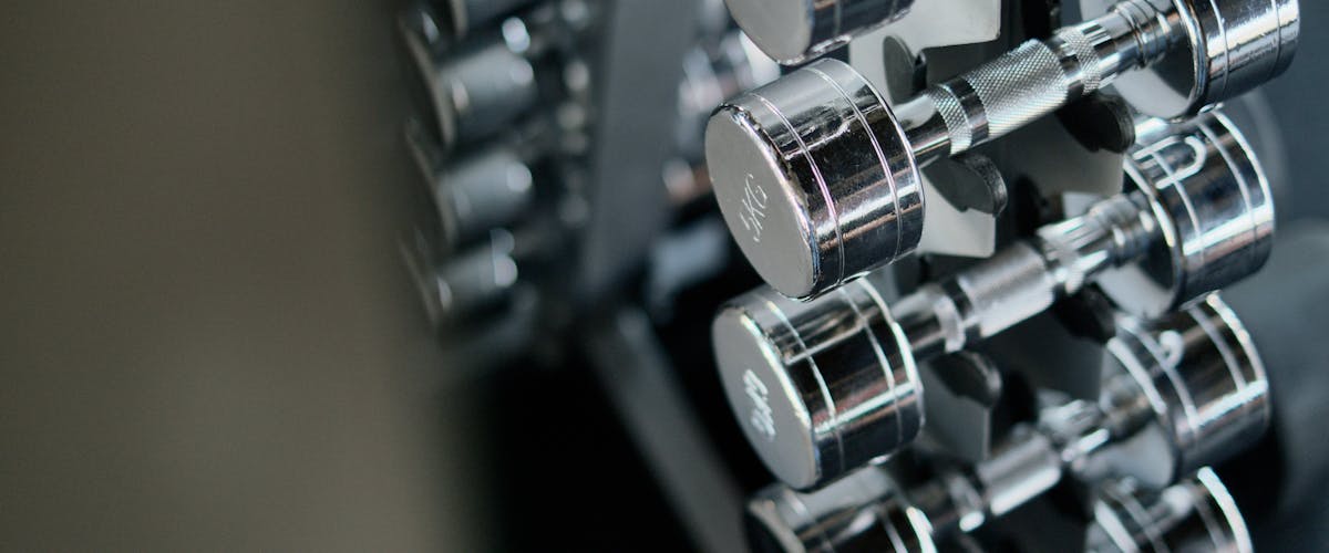 Chrome dumbbells on a weight rack